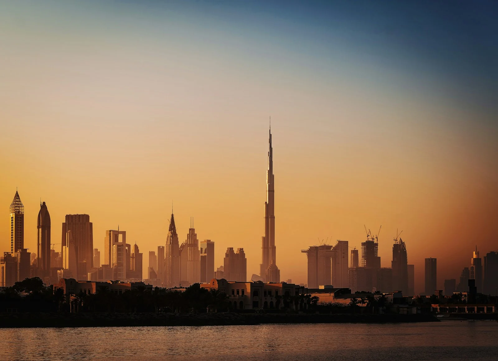 Dubai skyline beside the water at sunset