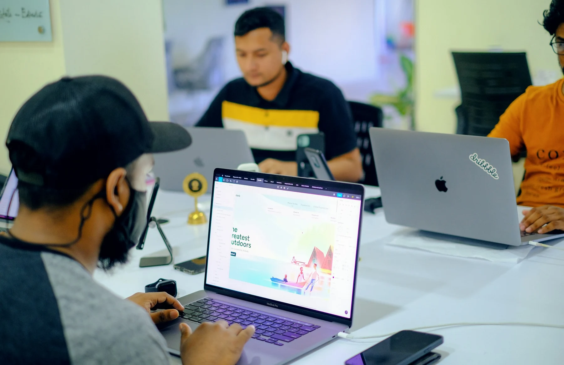 Designers working together on website layouts with laptops in a studio